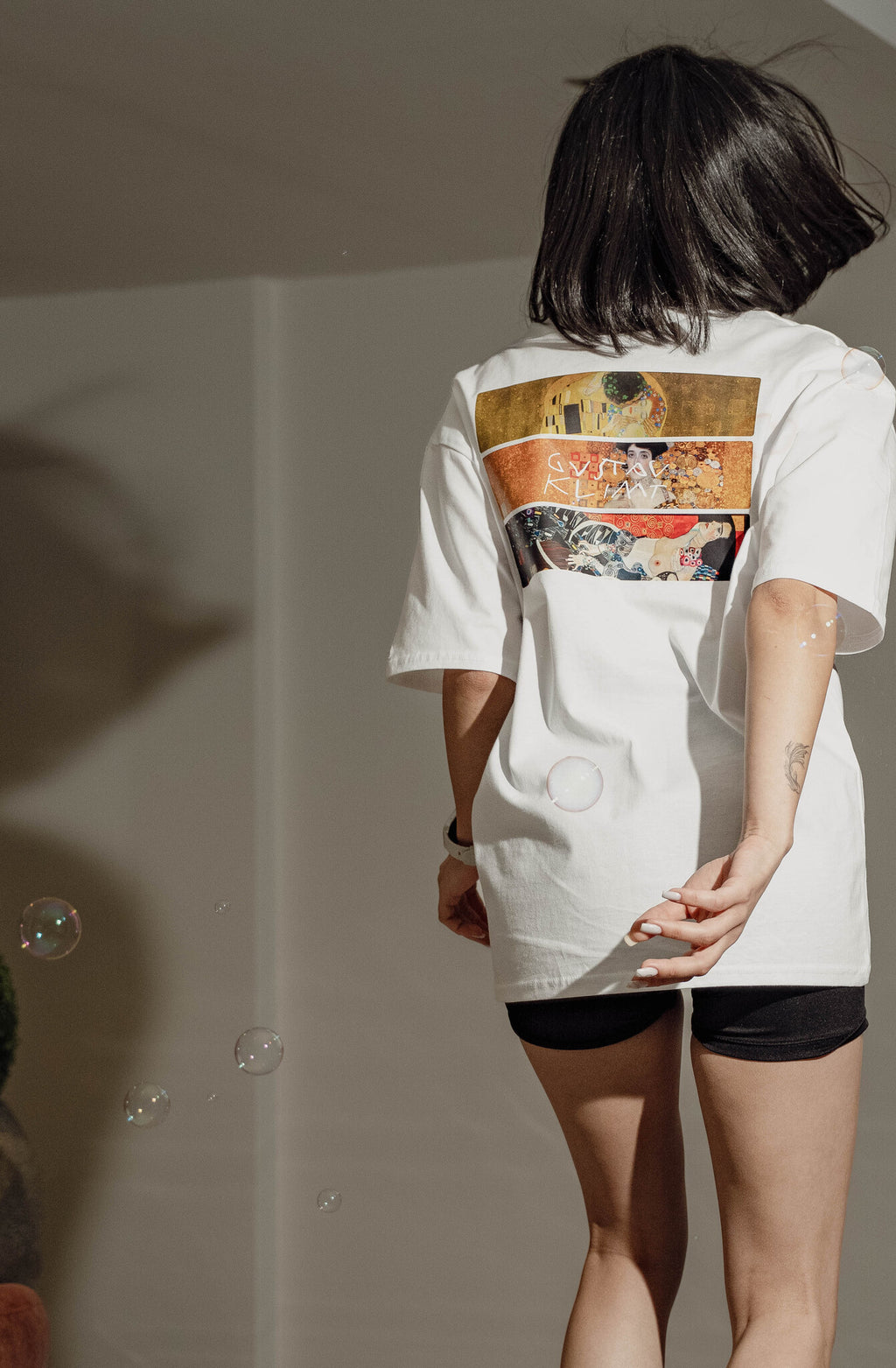 Gustav Klimt Altın Çağ baskılı beyaz oversize tişört giyen model – tam boy çekim